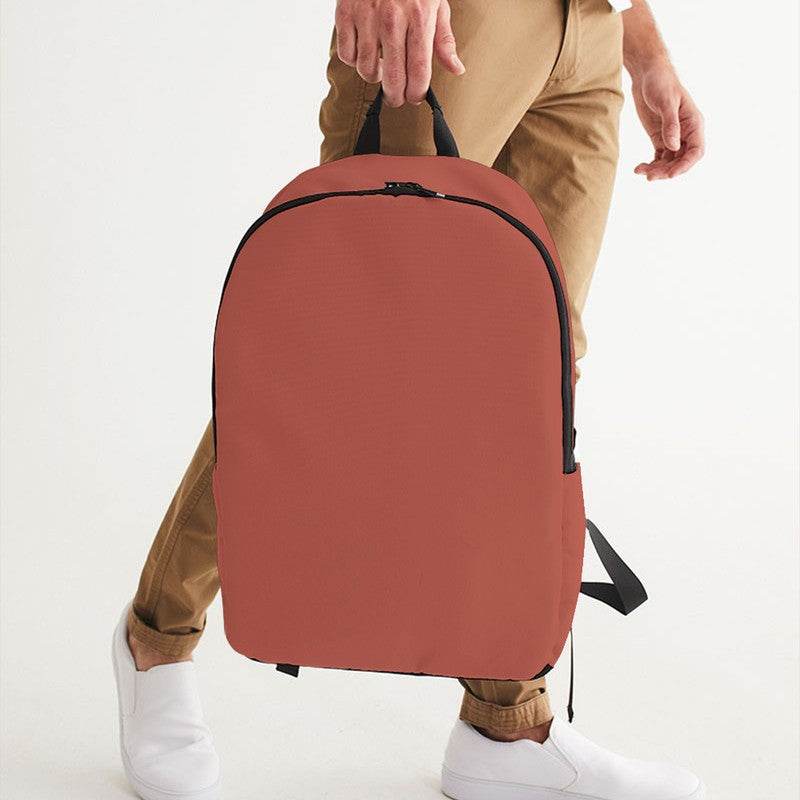 Medium Muted Red Waterproof Backpack (R-MU-ME) - Man Holding CloseUp
